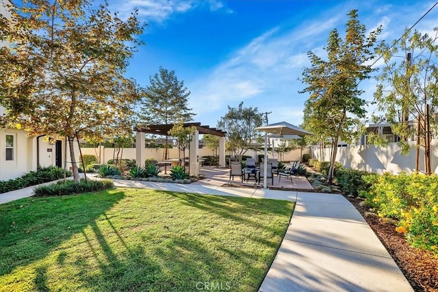 view of yard with a pergola and a patio area