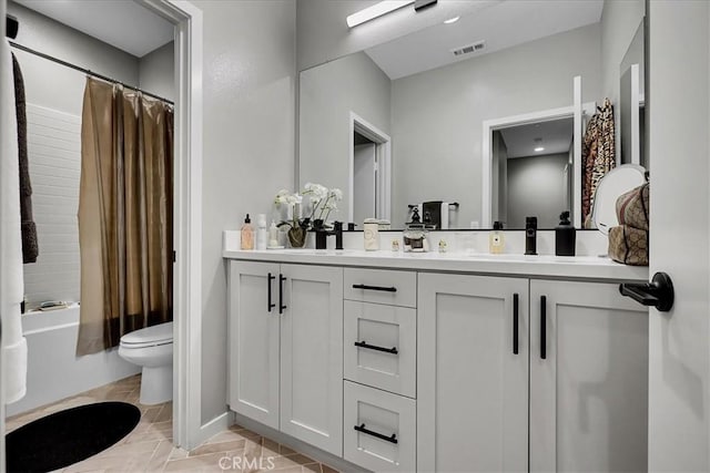 full bathroom with vanity, shower / tub combo, and toilet