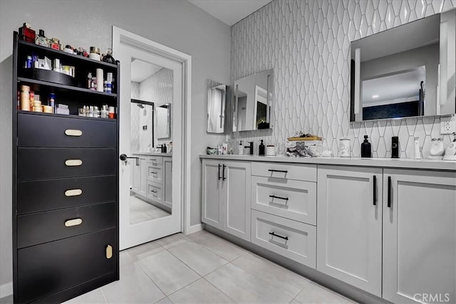 bathroom with walk in shower, vanity, tile patterned flooring, and tasteful backsplash