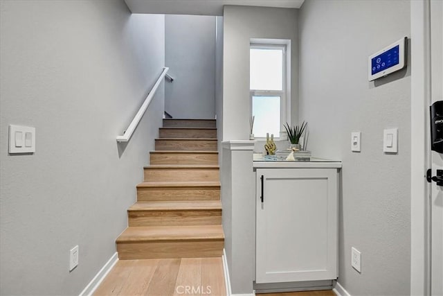 stairs featuring wood-type flooring