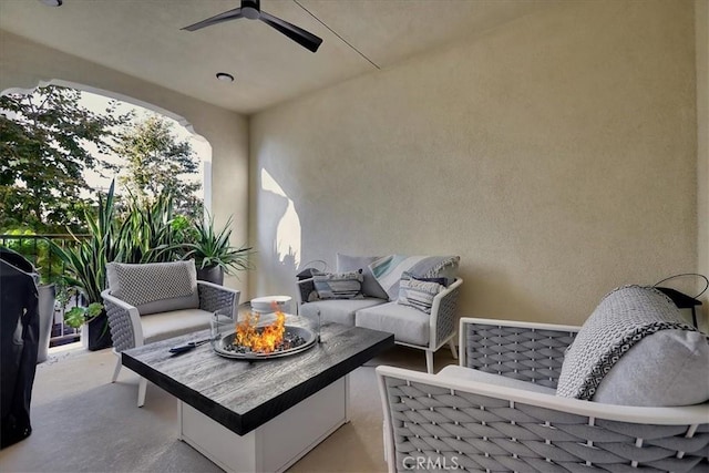 view of patio / terrace featuring an outdoor living space with a fire pit and ceiling fan