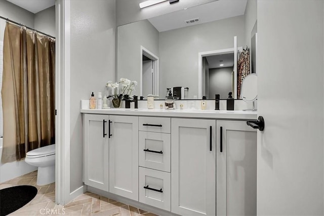 full bathroom featuring vanity, toilet, and shower / tub combo