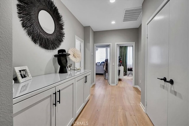 hallway with light hardwood / wood-style flooring