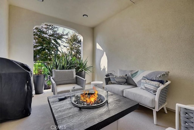 view of patio / terrace with grilling area and an outdoor living space with a fire pit