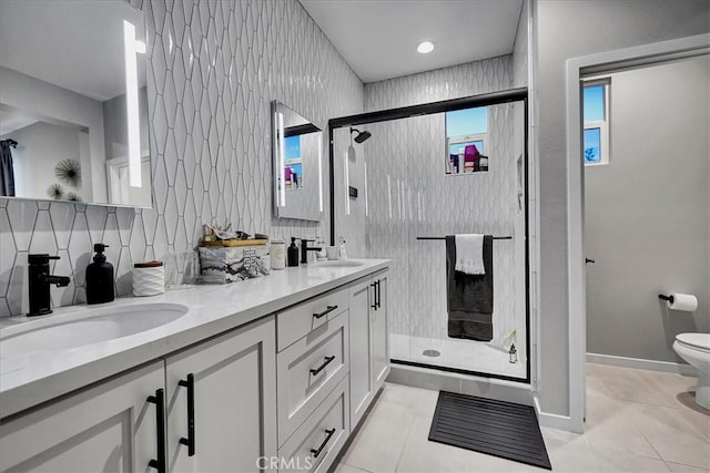 bathroom featuring walk in shower, vanity, toilet, and backsplash