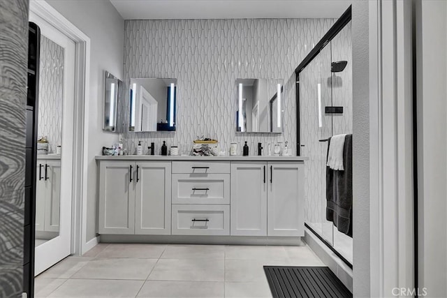 bathroom featuring walk in shower, tile patterned floors, and vanity