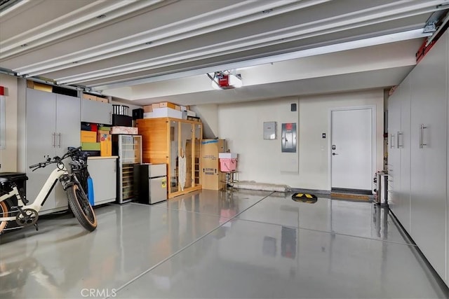 garage featuring a garage door opener and electric panel