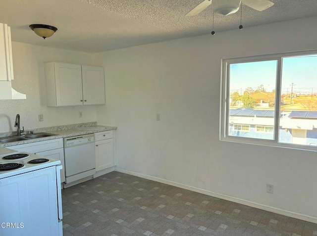 kitchen with white appliances, a textured ceiling, white cabinetry, sink, and ceiling fan