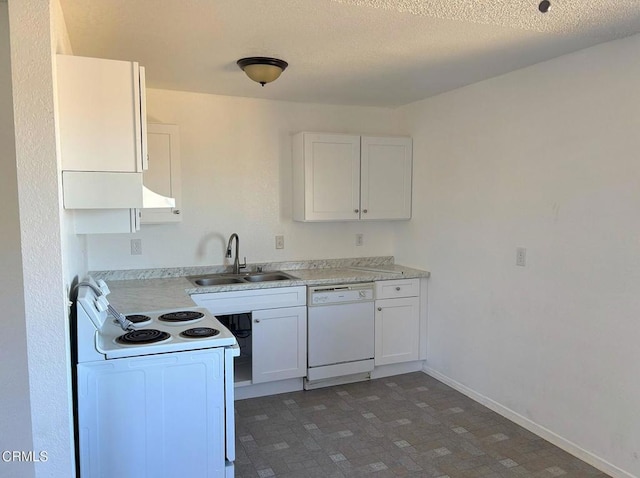 kitchen featuring sink, white appliances, white cabinets, and a textured ceiling