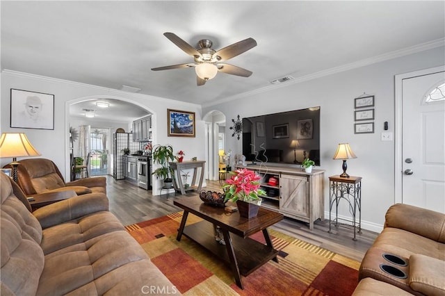 living room featuring crown molding, light hardwood / wood-style flooring, and ceiling fan