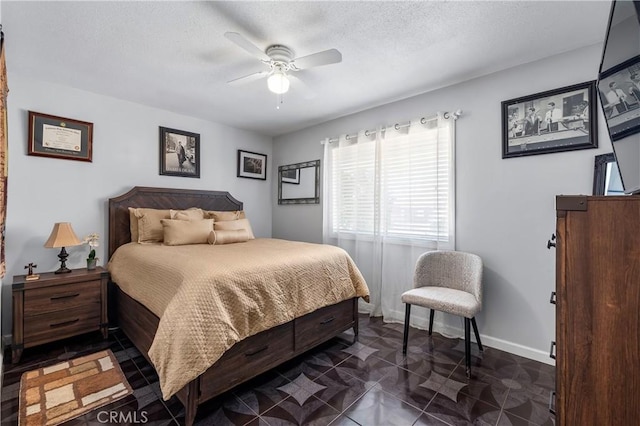 tiled bedroom featuring ceiling fan and a textured ceiling