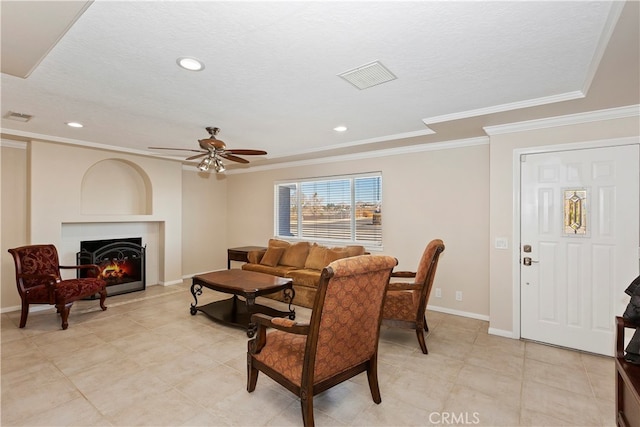 living room with ceiling fan and ornamental molding