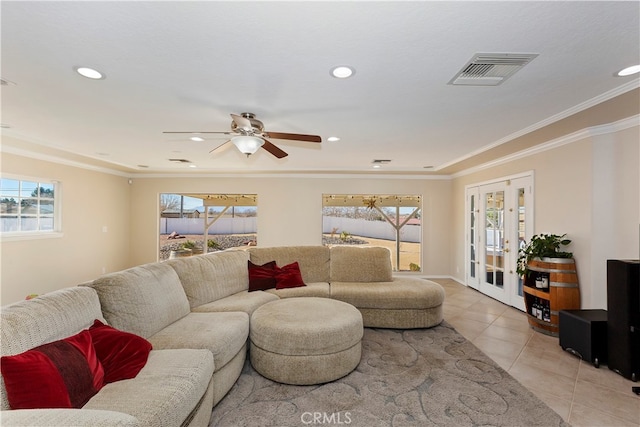 tiled living room featuring ceiling fan, ornamental molding, and french doors