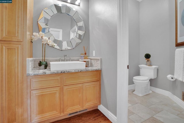 bathroom featuring toilet and vanity