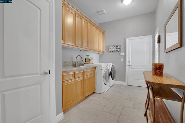 laundry room featuring sink, cabinets, and washer and dryer