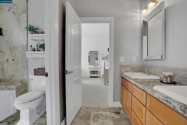 bathroom featuring toilet and vanity