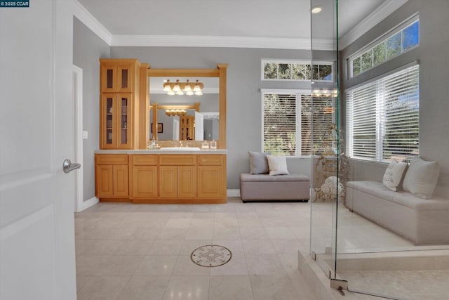 bathroom with an inviting chandelier, vanity, tile patterned floors, and ornamental molding