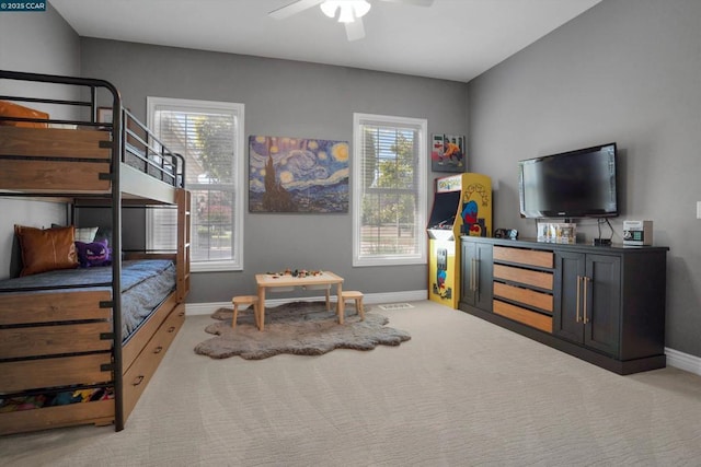 bedroom with ceiling fan and light carpet