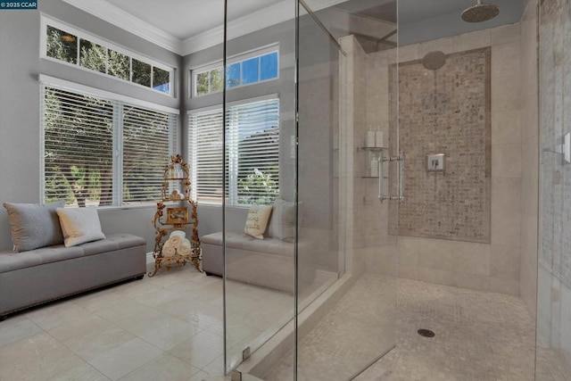 bathroom with a shower with shower door, a wealth of natural light, and crown molding