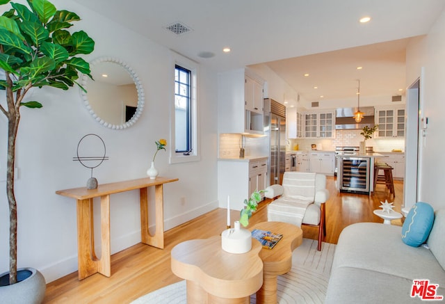 living room featuring light hardwood / wood-style flooring and beverage cooler