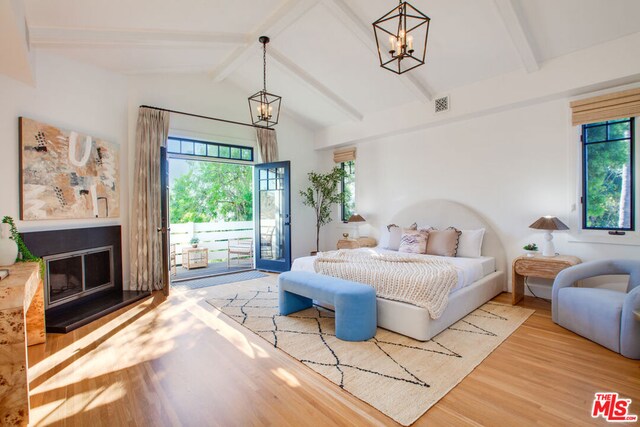 bedroom with hardwood / wood-style flooring, vaulted ceiling with beams, a notable chandelier, and access to outside