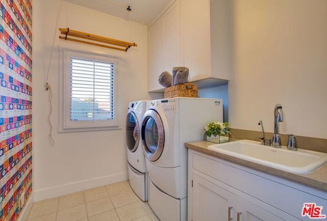 laundry room with cabinets, sink, independent washer and dryer, and light tile patterned flooring