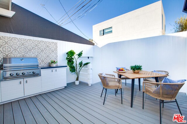 deck featuring area for grilling and an outdoor kitchen