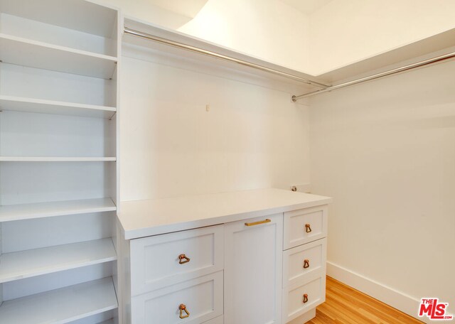 walk in closet featuring light hardwood / wood-style flooring