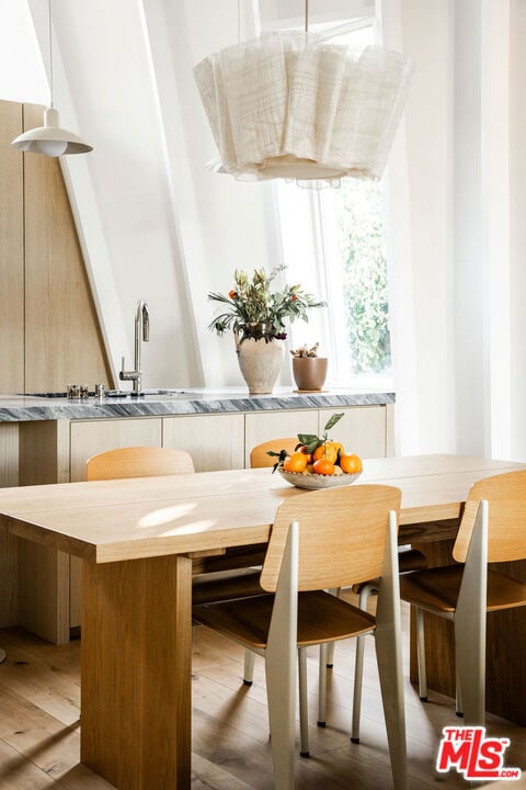 dining space featuring light hardwood / wood-style floors and sink