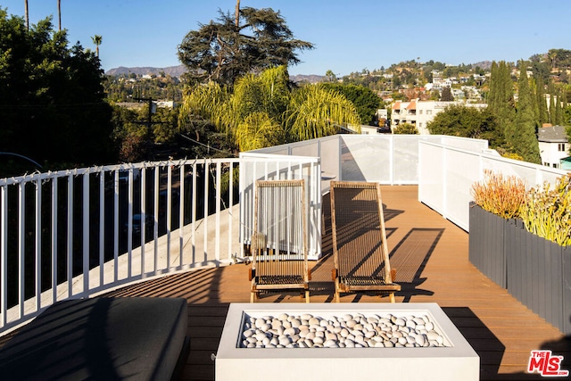 wooden deck with a mountain view