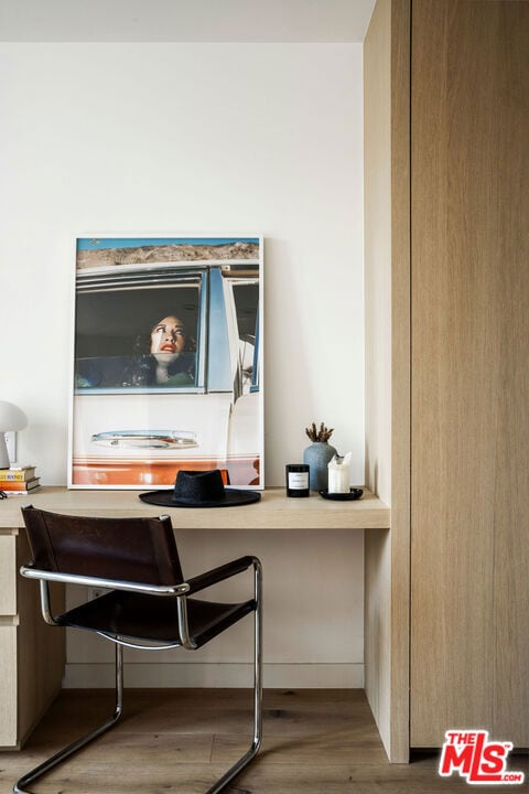 interior details with hardwood / wood-style floors and built in desk