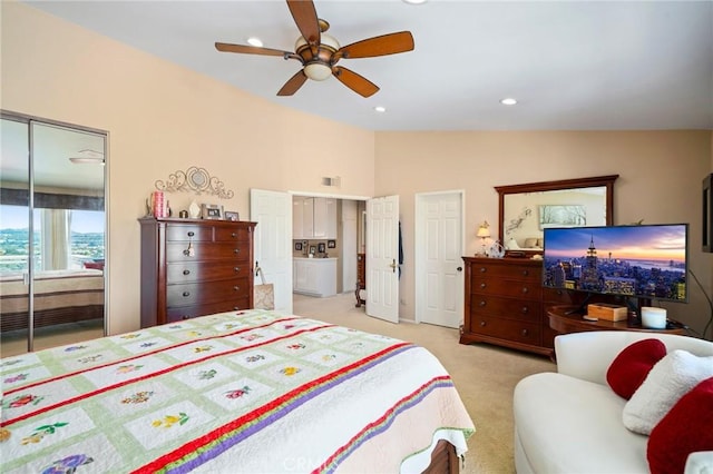 bedroom with vaulted ceiling, light colored carpet, and ceiling fan