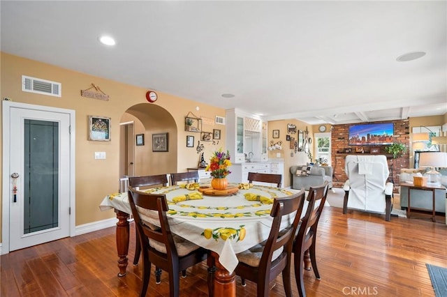 dining space featuring beamed ceiling and hardwood / wood-style floors