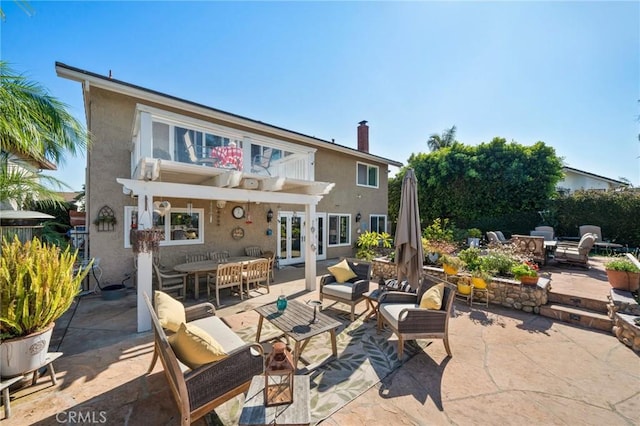 back of property featuring outdoor lounge area, a patio, and french doors