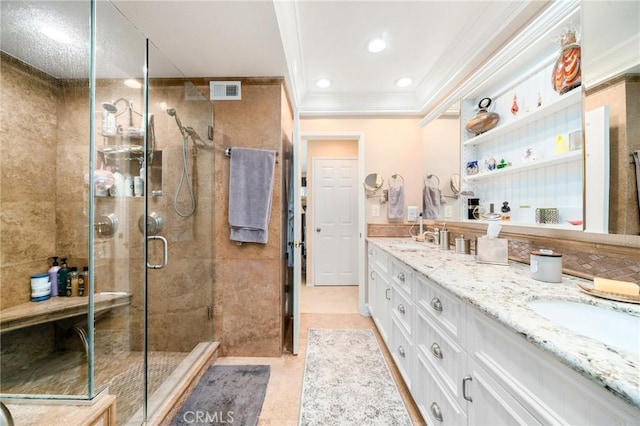 bathroom with a shower with door, vanity, ornamental molding, and tile patterned floors