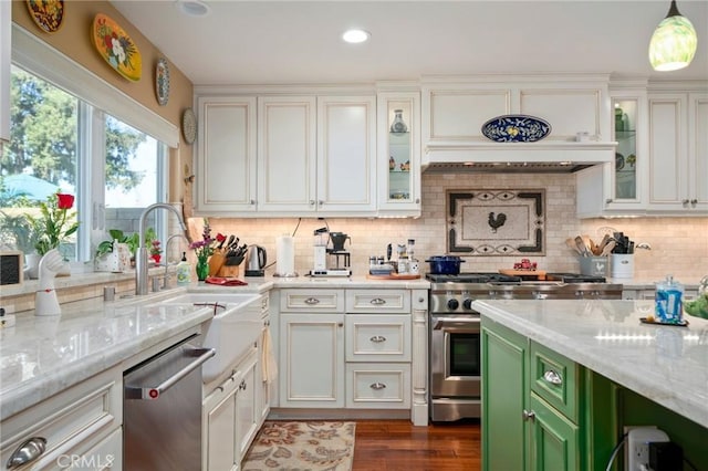 kitchen featuring tasteful backsplash, custom range hood, appliances with stainless steel finishes, and green cabinets