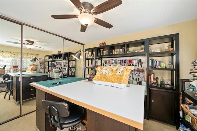 office area with light colored carpet and ceiling fan