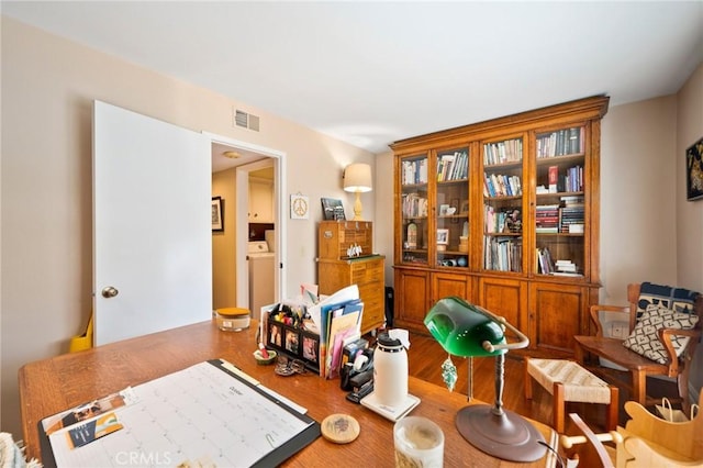 interior space featuring hardwood / wood-style flooring and washer / dryer