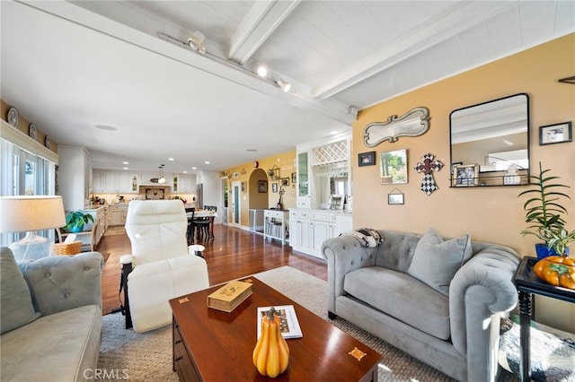 living room with wood-type flooring and beamed ceiling