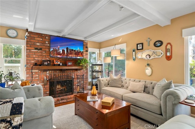 living room with beamed ceiling, a wealth of natural light, and a fireplace