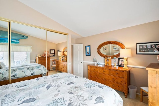 bedroom featuring carpet floors, a closet, and vaulted ceiling