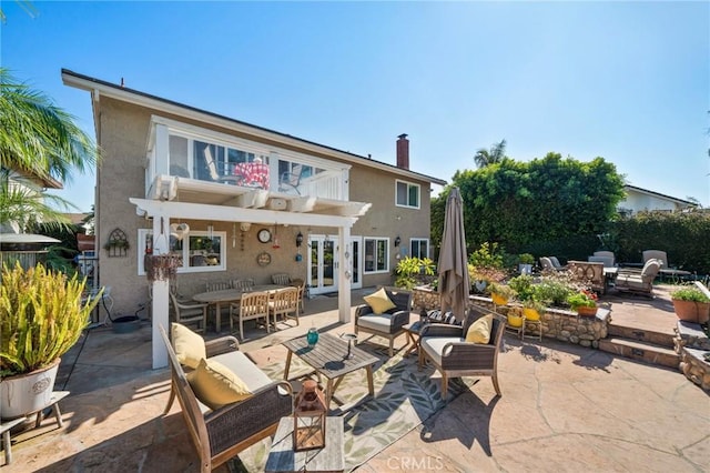 back of property featuring an outdoor living space, a patio, and french doors