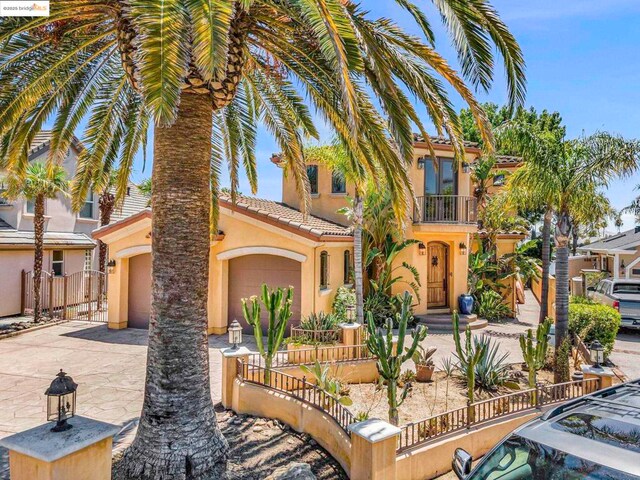 mediterranean / spanish-style house with a balcony and a garage