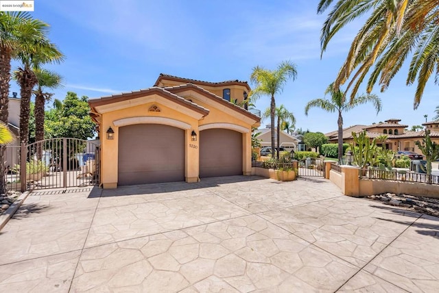 mediterranean / spanish-style home featuring a garage