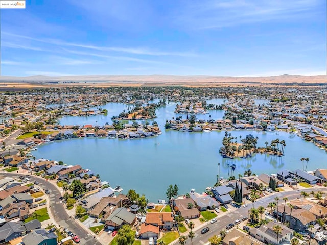 aerial view featuring a water and mountain view