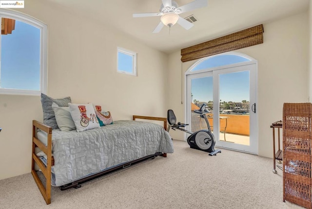 bedroom featuring access to exterior, ceiling fan, carpet floors, and multiple windows