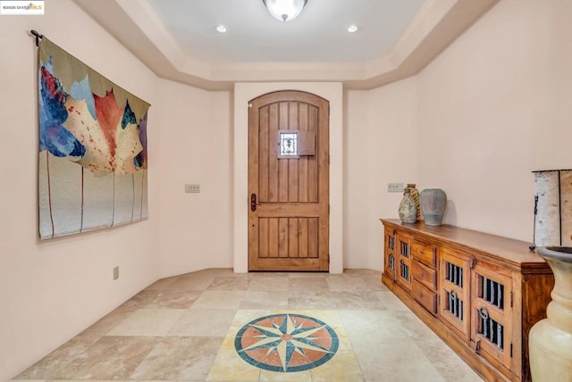 entryway with a tray ceiling