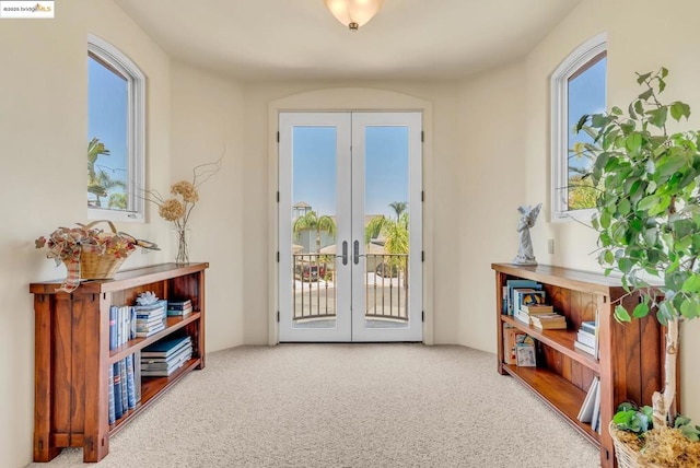 doorway with french doors and carpet flooring