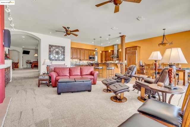 living room featuring light colored carpet and ceiling fan