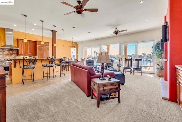 carpeted living room featuring ceiling fan